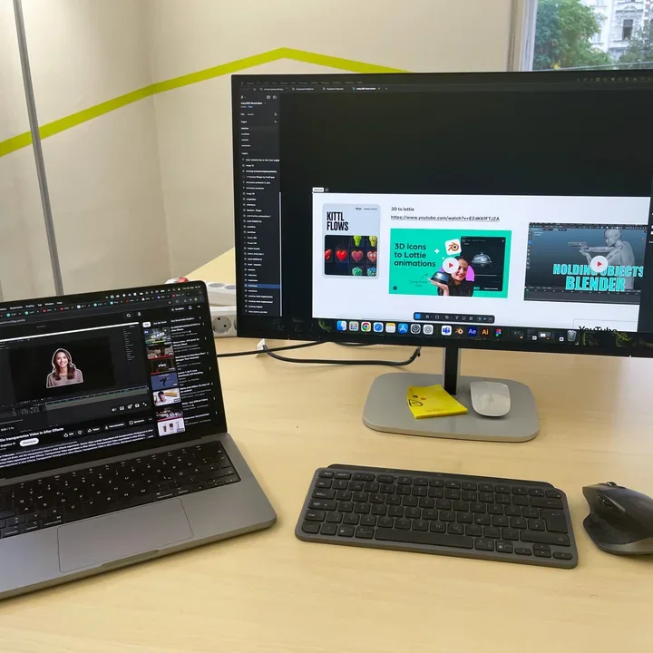 My desk with design references in Figma and a tutorial on the laptop.